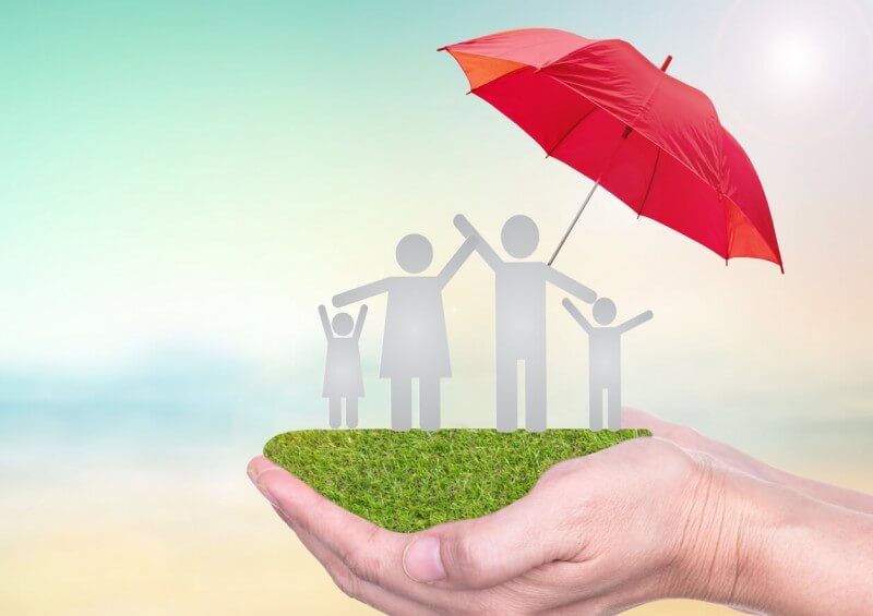 Family figures joyful under insurance umbrella
