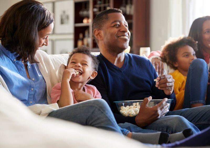 Family smiling in their home