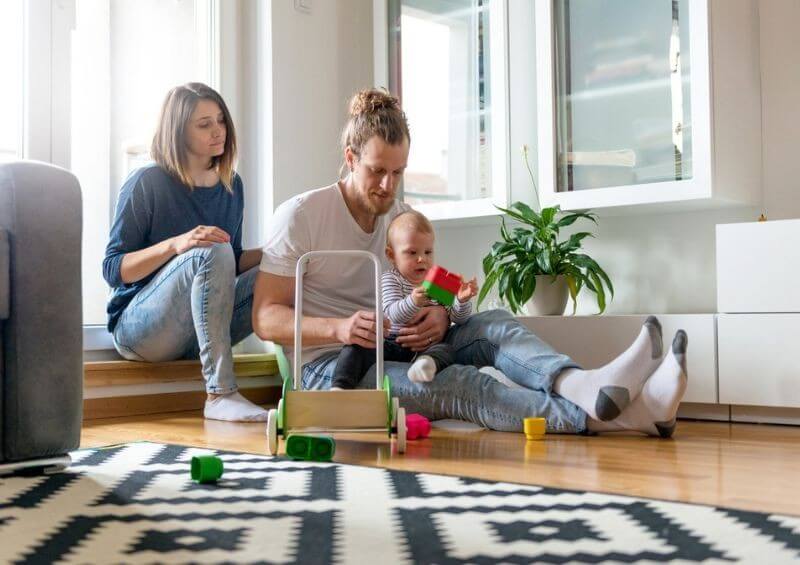 Young family sat in new home