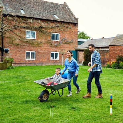 Two parents and their son having fun in their back garden